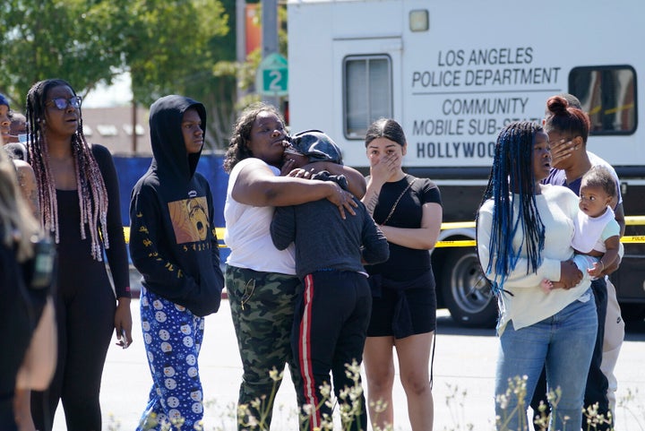 People react as Los Angeles County Medical Examiner-Coroner officials remove a body from a crime scene in Beverly Hills, California, June 25, 2021.