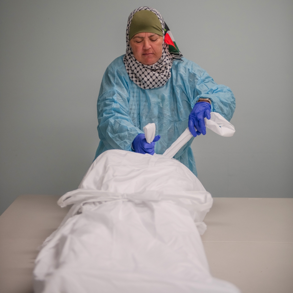 Ida Khalil demonstrates how to wash and prepare a body for burial at Beit Anan Community Center in Paterson, New Jersey, Oct. 22.