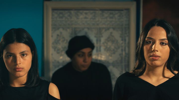 Tayssir (left) and Eya Chikhaoui with their mother, Olfa Hamrouni (in the background), in "Four Daughters."