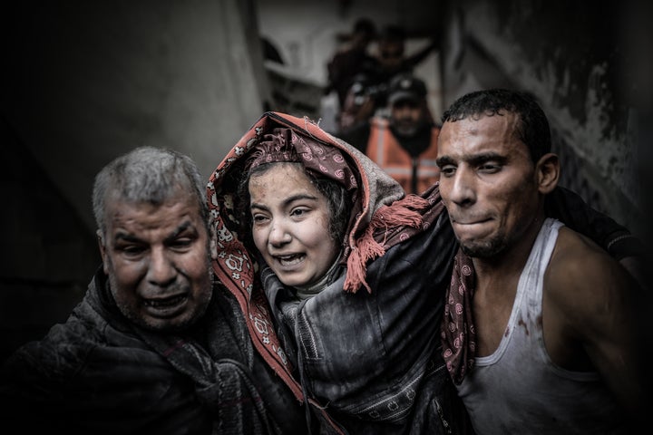 (EDITORS NOTE: Image depicts graphic content) Residents and civil defense teams rescue a Palestinian person under the rubble as they conduct a search and rescue operation around the rubble of the building that collapsed following an Israeli attack on house belonging to the Abu Saleh in Khan Younis, Gaza on December 7, 2023.