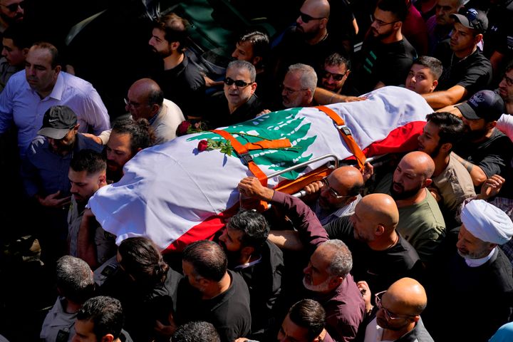 Mourners carry the body of Reuters videographer Issam Abdallah, who was killed by Israeli shelling in his hometown of Khiam, in southern Lebanon, on Oct. 14.