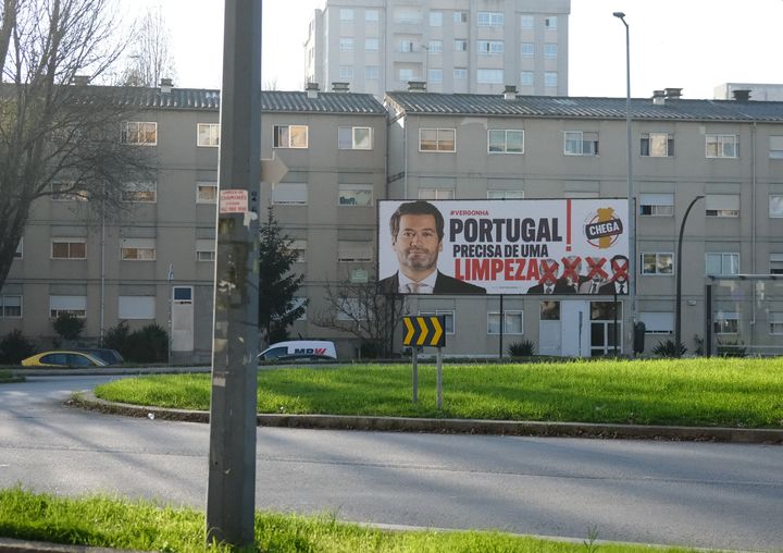 A campaign billboard for the far-right Chega party, calling for a political "cleansing" in Portugal, looms over a roundabout in central Porto, Portugal's second-largest city, on Nov. 19.