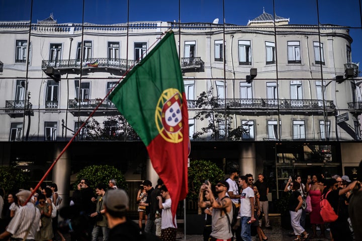 The reflection of a building is pictured during a demonstration in Lisbon for better housing conditions on Sept. 30. Thousands of people marched in the streets of Lisbon as well as in around 20 other cities to demand measures to address the housing crisis, which mainly affects large urban centers. The housing crisis has been brewing since Portugal, threatened with bankruptcy, appealed in 2011 for international financial aid.