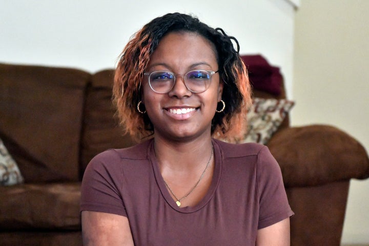 Jalen Matthews sits on her yoga mat in her home in Louisville, Ky., Monday, Dec. 4, 2023. She was diagnosed with sickle cell at birth and had her first pain crisis at age 9. Three years later, the disease led to a spinal cord stroke that left her with some paralysis in her left arm and leg. “I had to learn how to walk again, feed myself, clothe myself, basically learn how to do everything all over again,” said Matthews, who is now 26. (AP Photo/Timothy D. Easley)