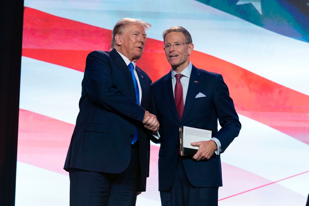 Former President Donald Trump (left) shakes hands with Tony Perkins, who helped found the Louisiana Family Forum. Mike Johnson acted as a lawyer for the Louisiana Family Forum as it pushed creationism in state public schools.