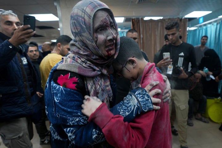 Palestinians wounded in the Israeli bombardment of the Gaza Strip are brought to the hospital in Deir al Balah on Friday, Dec. 8, 2023. (AP Photo/Adel Hana)