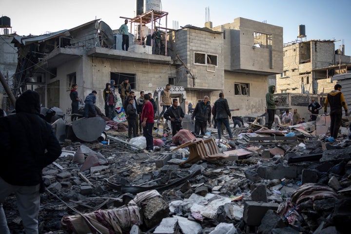 Palestinians look at houses destroyed in the Israeli bombardment of the Gaza Strip in Rafah on Saturday, Dec. 9, 2023. (AP Photo/Fatima Shbair)