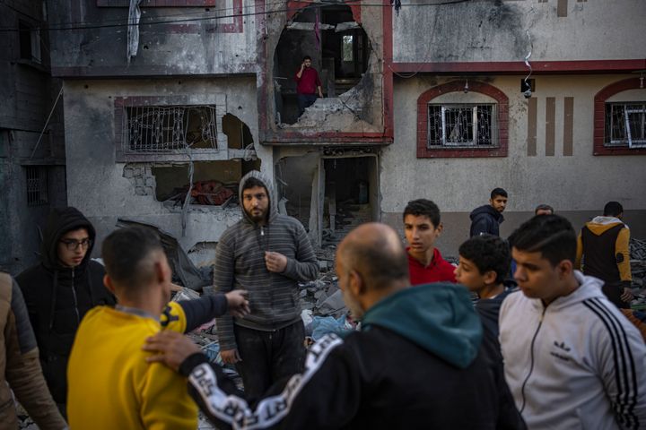 Palestinians look at houses destroyed in the Israeli bombardment of the Gaza Strip in Rafah on Saturday, Dec. 9, 2023. (AP Photo/Fatima Shbair)