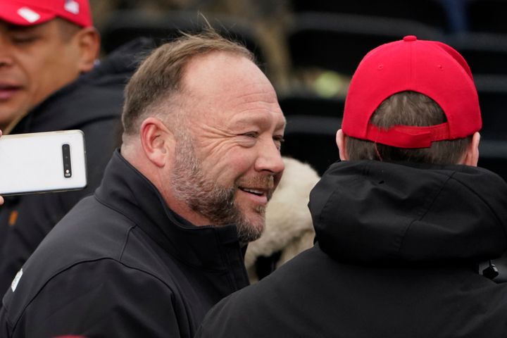 FILE - Alex Jones, left, attends a rally in support of President Donald Trump called the "Save America Rally," on Jan. 6, 2021, in Washington. Elon Musk has restored the X account of conspiracy theorist Alex Jones following a poll posted on the social media platform formerly known as Twitter on Saturday Dec. 9, 2023 that came out in favor of the Infowars host who repeatedly called the 2012 Sandy Hook school shooting a hoax. (AP Photo/Jacquelyn Martin, File)