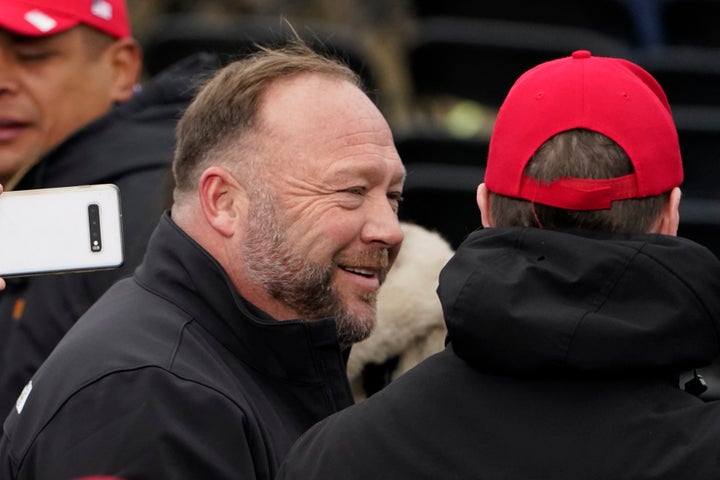 FILE - Alex Jones, left, attends a rally in support of President Donald Trump called the "Save America Rally," on Jan. 6, 2021, in Washington. Elon Musk has restored the X account of conspiracy theorist Alex Jones following a poll posted on the social media platform formerly known as Twitter on Saturday Dec. 9, 2023 that came out in favor of the Infowars host who repeatedly called the 2012 Sandy Hook school shooting a hoax. (AP Photo/Jacquelyn Martin, File)