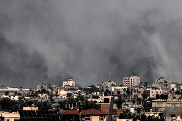 A picture taken from Rafah shows smoke billowing over Khan Yunis in the southern Gaza Strip during an Israeli strike on December 10, 2023, amid continuing battles between Israel and the Palestinian Hamas movement. Israeli forces pushed into southern Gaza on December 10, where hundreds of thousands of civilians have fled in search of shelter from bombardments and intense fighting with Hamas militants. (Photo by MAHMUD HAMS / AFP) (Photo by MAHMUD HAMS/AFP via Getty Images)