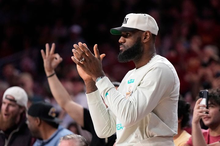 LeBron James claps after his son, Southern California guard Bronny James scored a three-point shot, his first college points, during the second half of an NCAA college basketball game against Long Beach State Sunday, Dec. 10, 2023, in Los Angeles. (AP Photo/Mark J. Terrill)