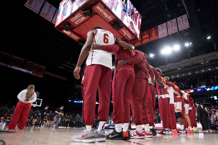 Southern California guard Bronny James (6) stand with the rest of his team during the national anthem prior to an NCAA college basketball game against Long Beach State Sunday, Dec. 10, 2023, in Los Angeles. (AP Photo/Mark J. Terrill)
