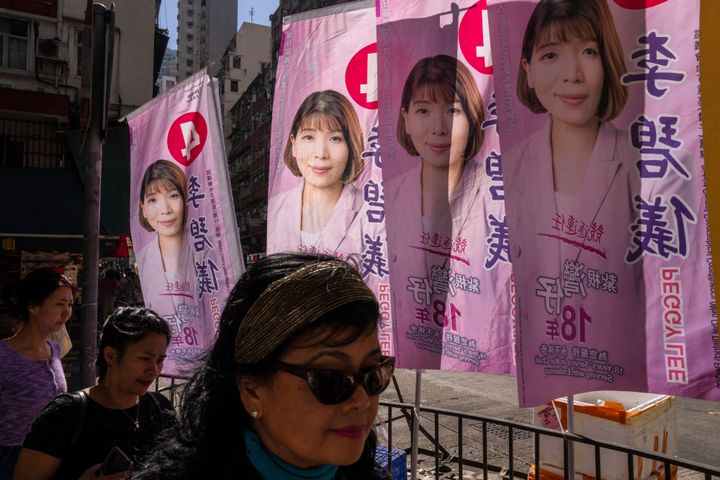 Pedestrians walk past posters promoting candidates during the District Council elections in Hong Kong, on Dec. 10, 2023. Residents went to the polls on Sunday in Hong Kong's first district council elections since an electoral overhaul was implemented under Beijing's guidance of “patriots” administering the city, effectively shutting out all pro-democracy candidates. 
