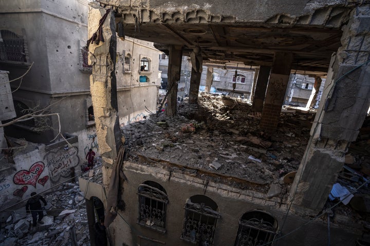 Palestinians check a house destroyed in the Israeli bombardment on Rafah, Gaza Strip, on Dec. 11, 2023. 