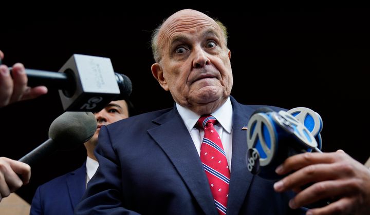 Former New York City Mayor Rudy Giuliani speaks to reporters as he leaves his apartment building in New York on Aug. 23.