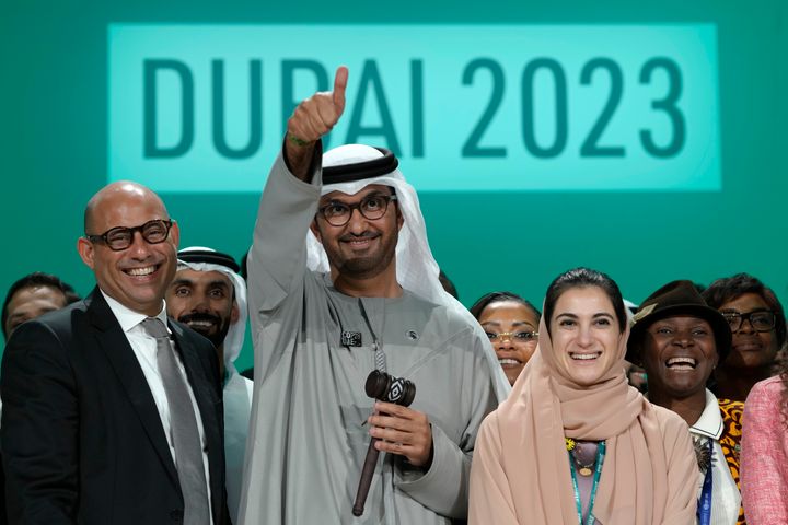 United Nations Climate Chief Simon Stiell, left, COP28 President Sultan Al Jaber and Hana Al-Hashimi, chief COP28 negotiator for the United Arab Emirates, pose for photos at the end of the COP28 U.N. Climate Summit on Dec. 13 in Dubai, United Arab Emirates. 