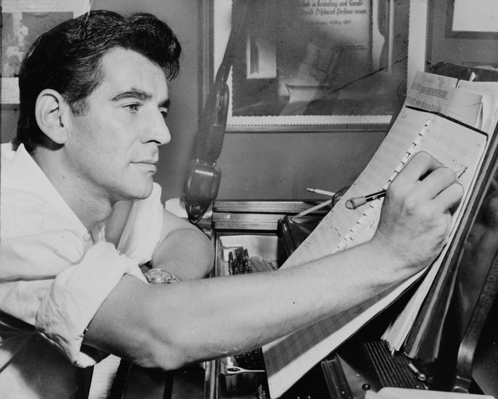 Leonard Bernstein makes notations to a musical score in 1955.