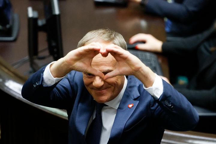 Donald Tusk forms a heart shape with his hands after he is elected as Poland's prime minister, in Warsaw, Poland, on Dec. 11, 2023.