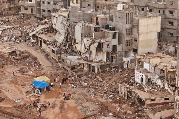 Rescuers and relatives of victims set up tents in front of collapsed buildings in Derna, Libya, on Sept. 18, 2023.