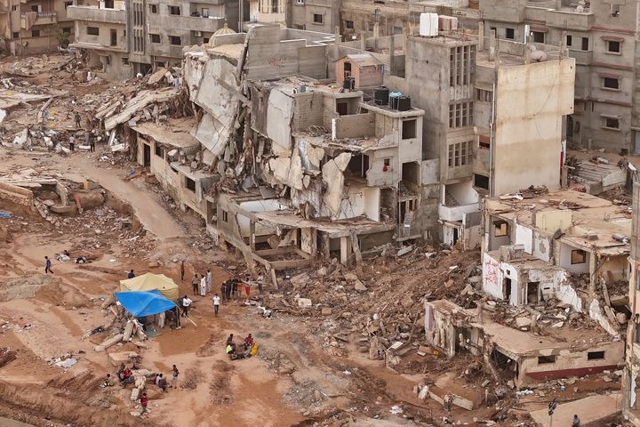 Rescuers and relatives of victims set up tents in front of collapsed buildings in Derna, Libya, on Sept. 18, 2023.