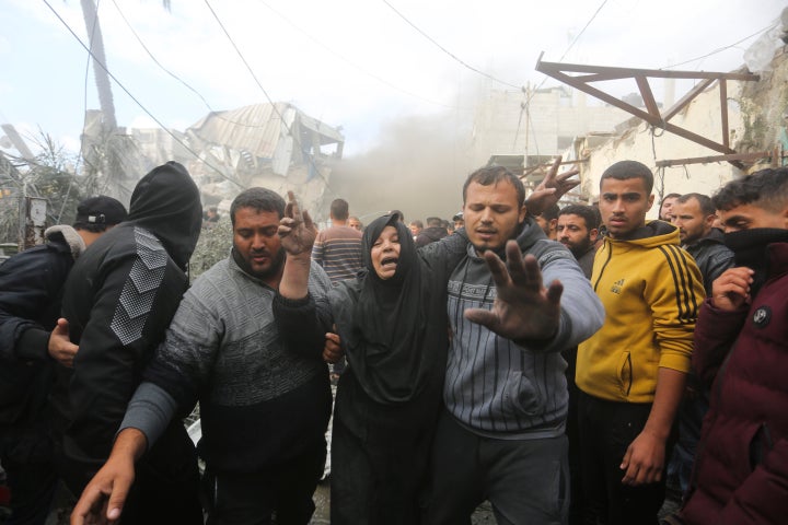 CORRECTS DATE Palestinians evacuate survivors of the Israeli strike in Rafah, Gaza Strip, Thursday, Dec. 14, 2023. (AP Photo/Hatem Ali)