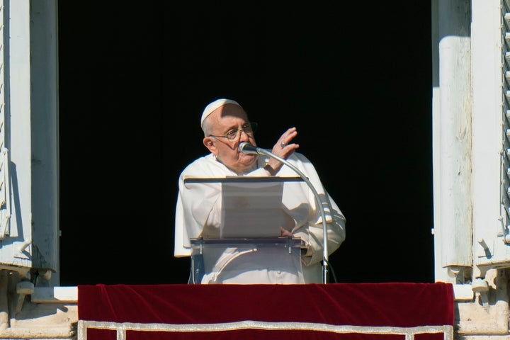 Pope Francis delivers his blessing during the Angelus noon prayer from the window of his studio overlooking St. Peter's Square, at the Vatican on Sunday.