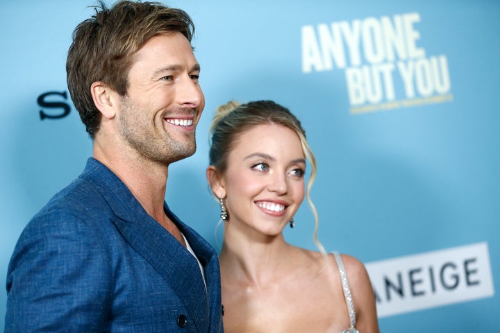 Hearsay about Glen Powell (L) and Sydney Sweeney's purported off-screen romance began circulating when they started filming "Anyone But You" in Australia.