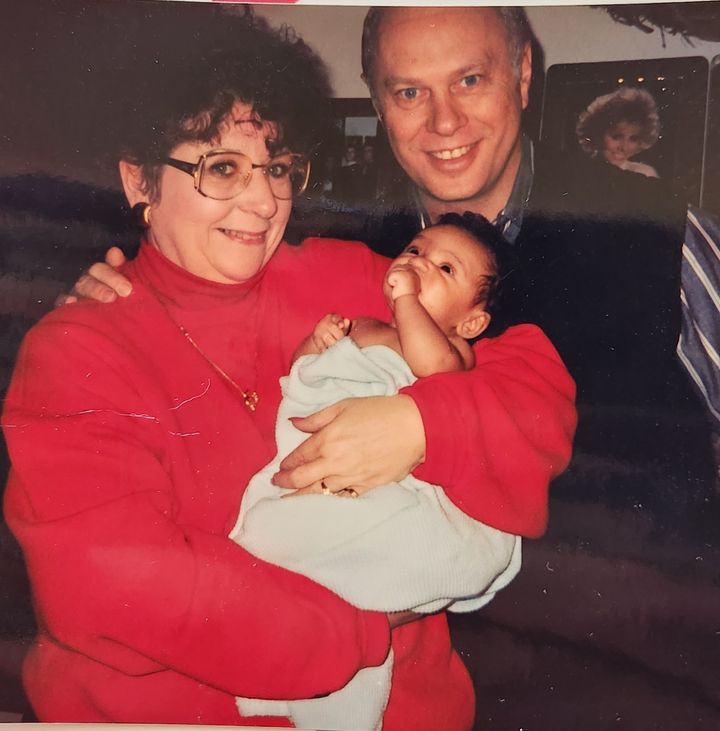 The author's parents holding Kristil, her daughter.