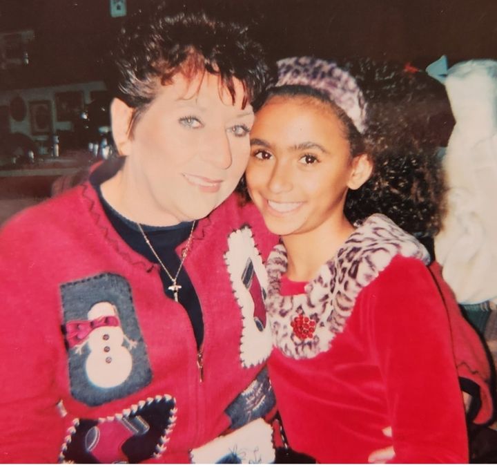 The author's mom and Kristil as a child celebrating Christmas.