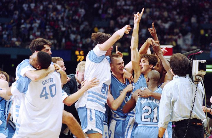 Montross' UNC teammates embrace him after winning the national championships in 1993.