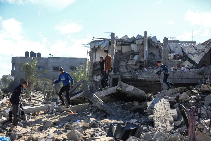 Palestinians inspect destroyed buildings following the Israeli bombing of Rafah in the southern Gaza Strip.