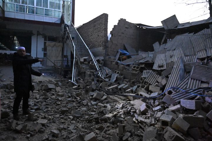 A resident looks at a collapsed building after an earthquake in Jishishan County, in northwest China's Gansu province on December 19, 2023. 