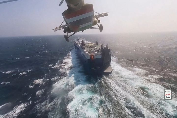 This photo released by the Houthi Media Center shows a Houthi forces helicopter approaching the cargo ship Galaxy Leader on Sunday, Nov. 19, 2023. Yemen's Houthis have seized the ship in the Red Sea off the coast of Yemen after threatening to seize all vessels owned by Israeli companies.