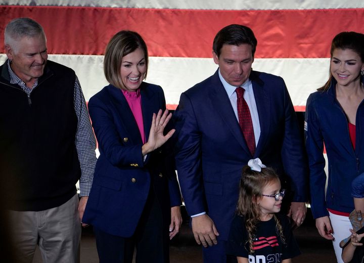 Iowa Gov. Kim Reynolds (second from left) joins Florida Gov. Ron DeSantis (third from left) during a rally in Iowa last month.