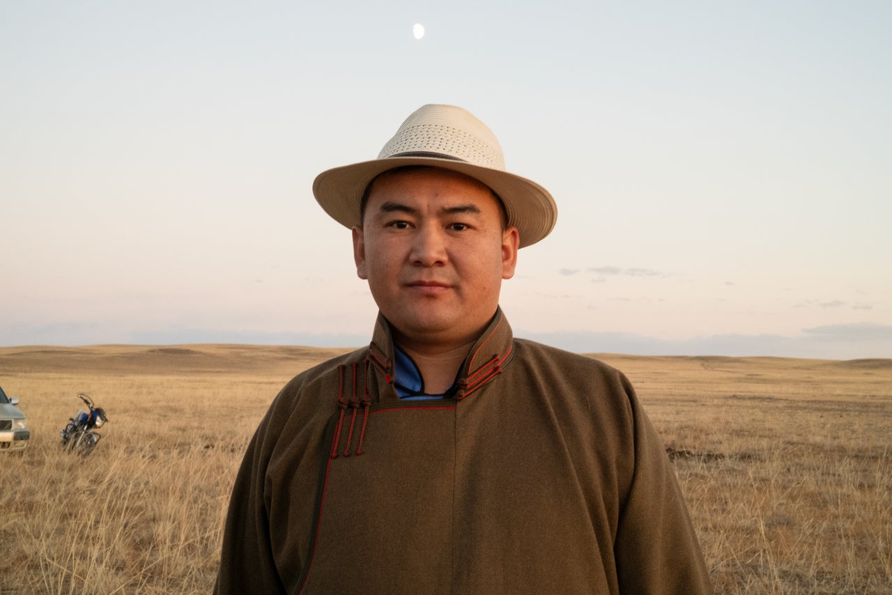 Batbayar Adyatogtokh, 33, the mayor of the village "soum" of Sant in central Mongolia, stands outside the ger where his family prepared a barbecue feast one night in October.