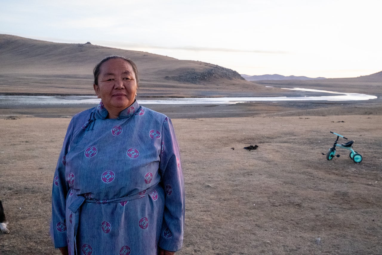 Batdulam Gombo-Ochir outside the ger home she shares with her son, daughter-in-law and grandchildren. She fears that extreme weather and rising consumer prices will drive many herders to give up on the traditional lifestyle and seek jobs in the city.