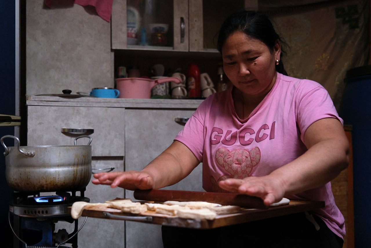 Ishtsooj Davagdorj presents dough to fry for a cookie-like biscuit called boortsog, a Mongolian staple, one night in October.