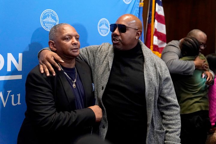 Alan Swanson (left) is embraced by Joey Bennett, nephew of Willie Bennett, following Boston Mayor Michelle Wu’s formal apology Wednesday. Joey Bennett accepted the apology on behalf of his uncle, who was not present at the news conference.