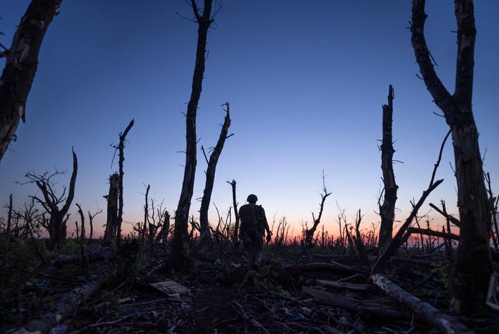 Ukrainian servicemen walk through a charred forest at the frontline a few kilometers from Andriivka, Donetsk region, Ukraine, on Sept. 16, 2023.