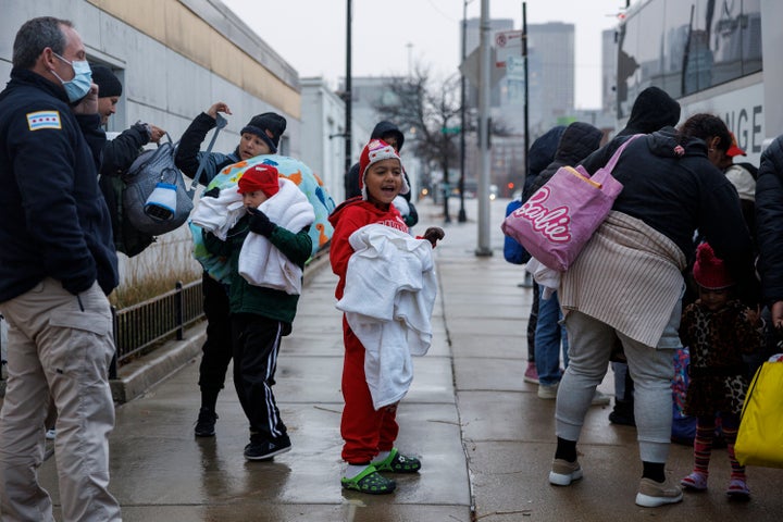 A group of migrants exit a bus after traveling from Texas to Chicago on Dec. 5.