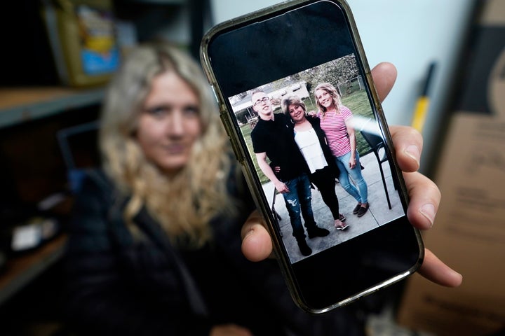 Lisa Hohnstreiter holds a smartphone displaying a photograph of her mother, Nancy Harrison, and her brother, Friday, Nov. 24, 2023, in Warren, Mich. Not long after DeAngelo Martin was released from jail, he killed for the second time. On March 19, 2019, the body of Nancy Harrison, 52, was discovered in an abandoned house on Coventry Street. (AP Photo/Carlos Osorio)