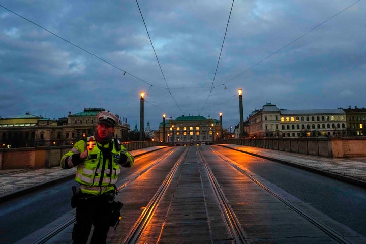 A police officer secures a street after a shooting in downtown Prague, Czech Republic, on Dec. 21, 2023.