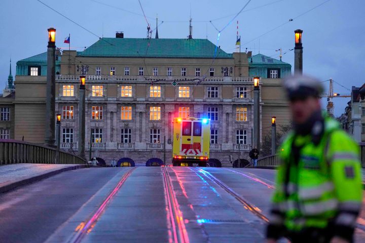 An ambulance drives towards the building of Philosophical Faculty of Charles University in downtown Prague, Czech Republic, Thursday, Dec. 21, 2023. (AP Photo/Petr David Josek)