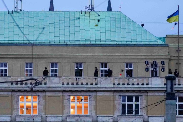 Police officers stand on the balcony of Philosophical Faculty of Charles University in downtown Prague, Czech Republic, Thursday, Dec. 21, 2023. (AP Photo/Petr David Josek)