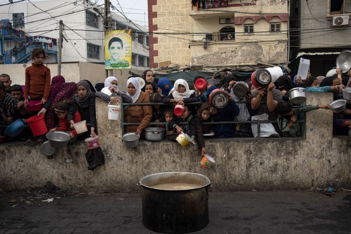 Palestinians line up for a free meal in Rafah, Gaza, on Dec. 21. International aid agencies said Gaza is suffering from shortages of food, medicine and other basic supplies as a result of the 2 1/2-month war between Israel and Hamas. 