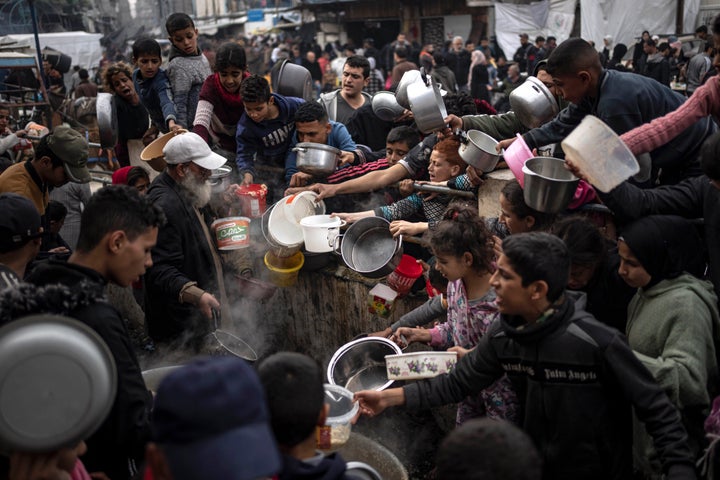 Palestinians converge for a free meal in Rafah, Gaza Strip, on Dec. 21, 2023.