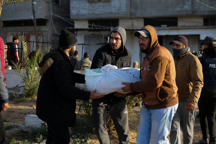 Palestinians carry the bodies of the Dhair family, killed in the Israeli bombardment of the Gaza Strip, during their funeral in Rafah on Dec. 22, 2023.