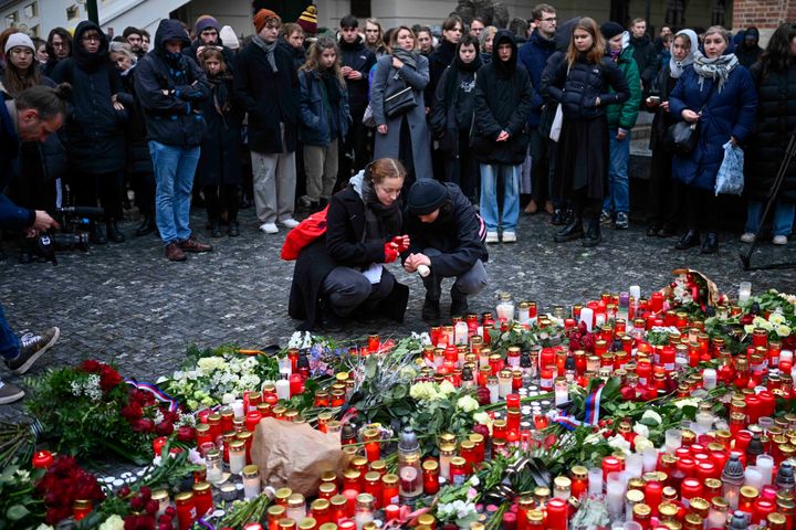 Mourners lay candle lights outside the headquarters of Charles University for victims of mass shooting in Prague, Czech Republic, on Dec. 22, 2023.