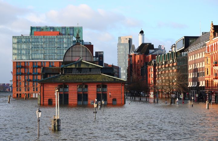 In Hamburg, the Elbe River flooded streets around the city’s fish market, with water waist-high in places.